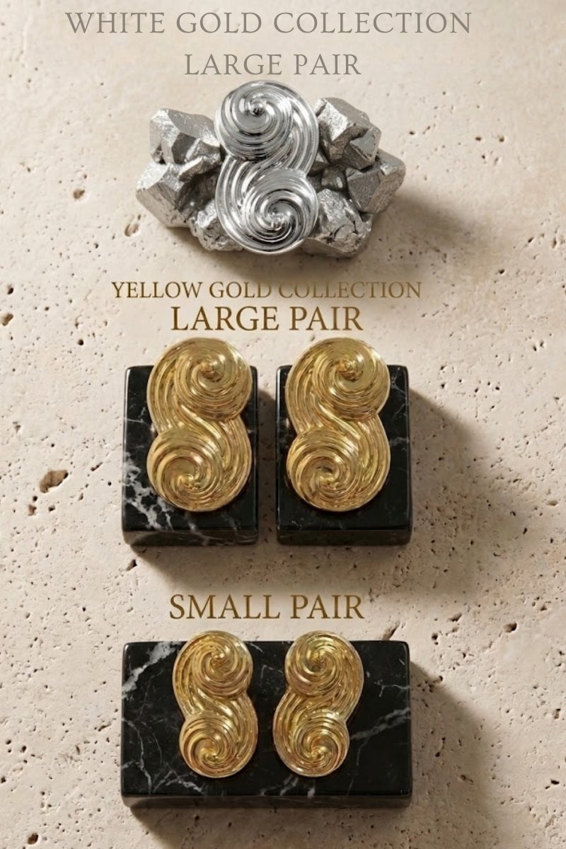 An elegant display of the Seraphina collection, featuring small and large pairs in both yellow gold and white gold on marble bases.