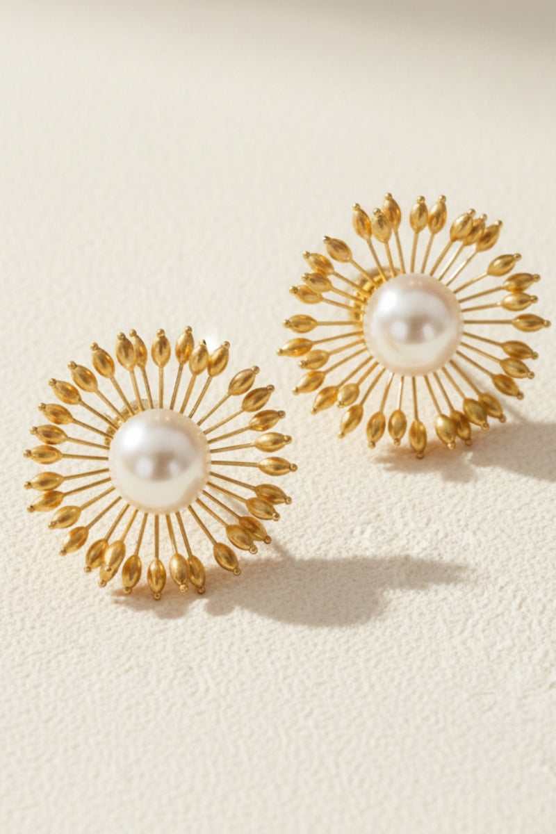 Hera vintage sunburst pearl earrings with a baroque pearl center and gold-plated ray frame for 80s glam.