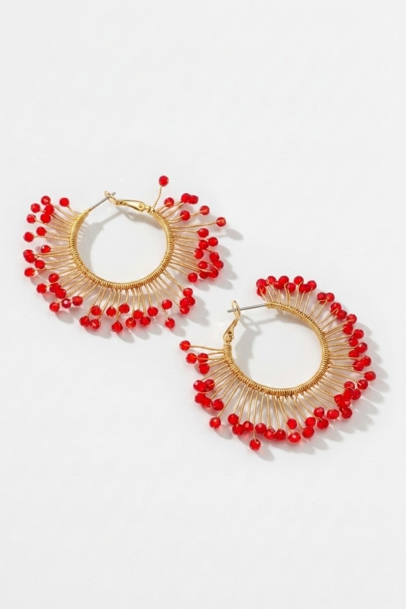 Pair of solburst wire-wrapped beaded sunburst hoop earrings in the Crimson variant on a white background