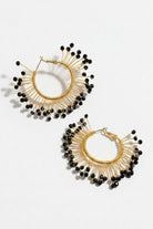 Pair of solburst wire-wrapped beaded sunburst hoop earrings in the Noir variant on a white background