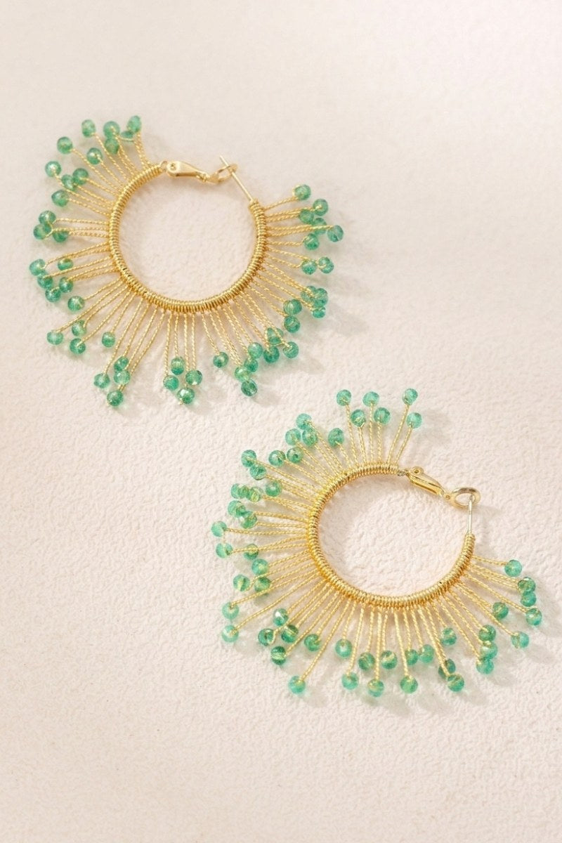 Solburst wire-wrapped beaded sunburst hoop earrings in the Seafoam variant on a warm beige background