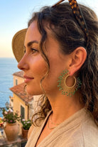 Model wearing solburst wire-wrapped beaded sunburst hoop earrings in the Seafoam variant, view 3