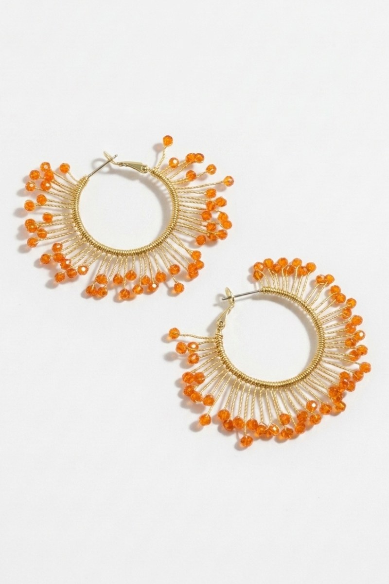 Pair of solburst wire-wrapped beaded sunburst hoop earrings in the Tangerine variant on a white background