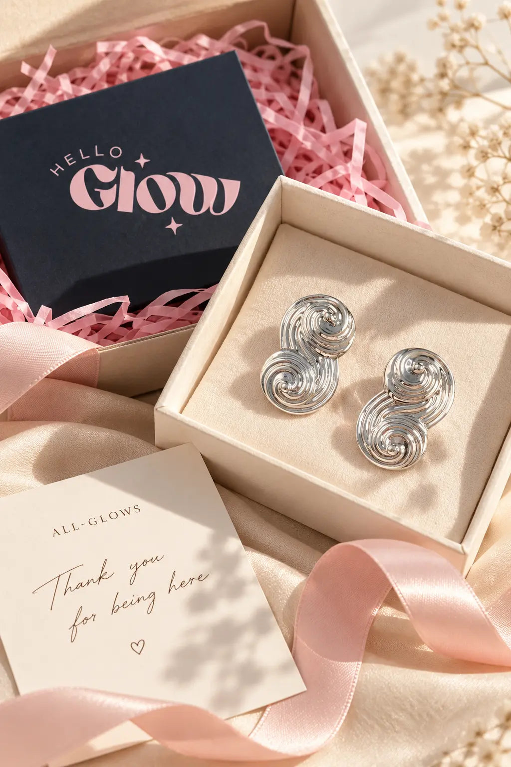 Silver-tone Seraphina swirl earrings presented with All-Glows gift packaging
